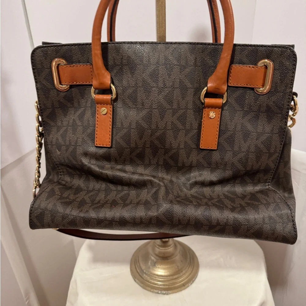 Michael Kors Emblemed satchel style purse. Strap has some gold chain and leather